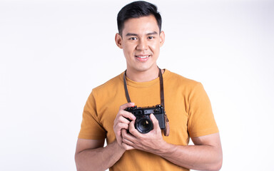 Asian man holding camera for traveling and standing on white background