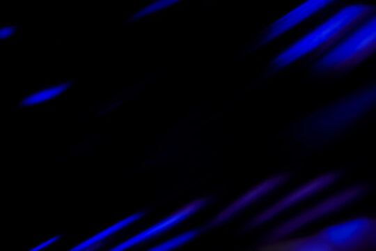 Blur colorful neon light leaks on black background. Defocused illuminated abstract futuristic texture for using over photos as overlay or screen filter