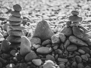 black white Stone pyramid on the background of stone desert symbolizing stability, zen, harmony and...