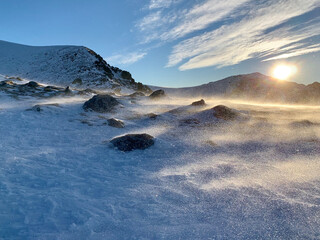 Snow day in the mountain with a lot of wind and blue sky