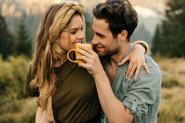 Young couple having fun drinking morning coffee together