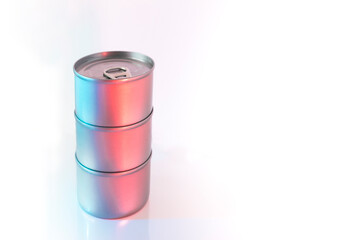 Closed cans with a dark background and colored lights. Danger of canned food and the health effects of bisphenol A