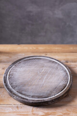 Pizza or bread cutting board and scattered wheat flour powder for homemade baking on wooden table