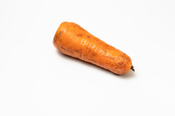 a Dirt-stained carrot isolated on white background