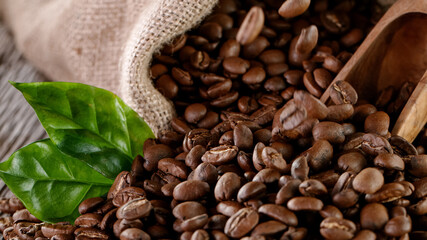 Falling Roasted Coffee Beans on Brown Background, close-up.