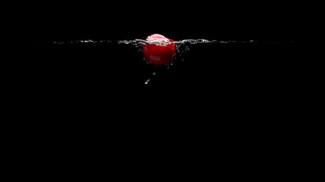 The cherry falls into the clear water. Black background. 3D-render.