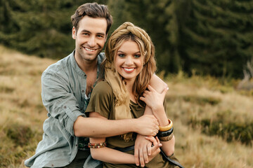Loving young couple hugging and smiling together on nature background