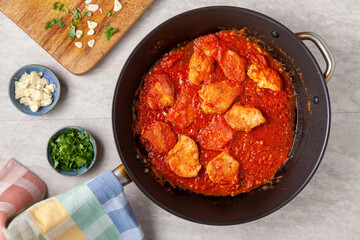 Poultry stew in tomato sauce on big pan. Romanian cuisine. Food top view.