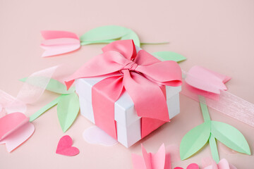 Holiday card pink background with gift, Naive paper cut flowers tulips. Valentine's Day, Happy Women's Day, Mother's Day, Birthday, Wedding, space for text, foil baloon, stylish flyer, close up