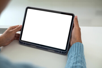 Mock up. Man holding tablet white blank screen at home.
