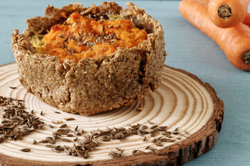 Pie with carrot and potato filling with caraway seeds. Rye flour homemade pastry.