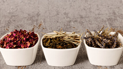 Dried plants parts in bowls. Lavender, lemongrass, green tea and rose petals. Self made potpourri.
