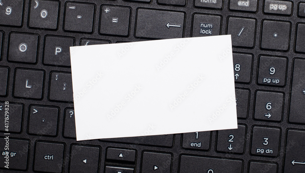 Aufkleber the computer keyboard has a white blank card for inserting text. template. top view with copy space