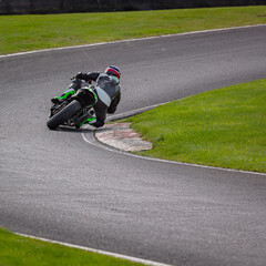 A shot of a racing motorbike as it circuits a track.