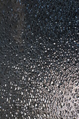 Translucent Glass Close-up Surface with Refractive Light. Uneven Bumpy Semitransparent Texture Background