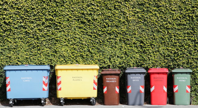 Group Of Coloured Recycling Bins On The Street For Paper Plastic Organic Dry Can And Glass In Italy