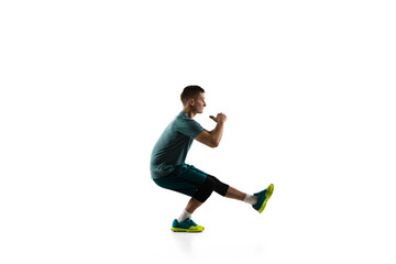 Fototapeta premium Stretching. Young caucasian male model in action, motion isolated on white background with copyspace. Concept of sport, movement, energy and dynamic, healthy lifestyle. Training, practicing. Authentic