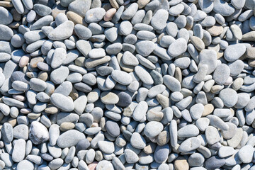 White pebbles on the beach by the sea as a natural background