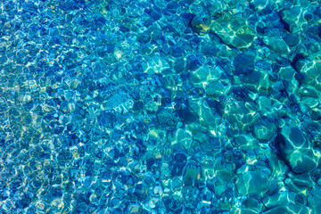 Multicolored pebbles and stones on the bottom of the sea underwater as a natural background