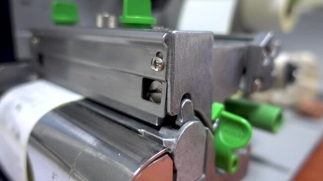 Working with a bar code printer. Direct thermal and thermal transfer label printmaking technique. Manufacturing label printing device.
