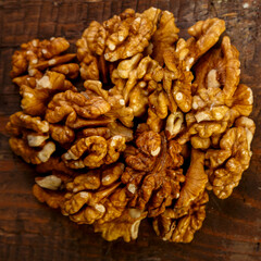 Walnuts scattering on a wooden table. Square