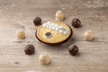 close up on the details of a lemon cake next to chocolate balls, studio