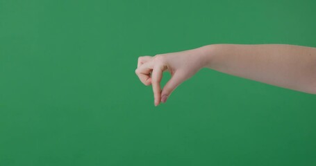 Woman hand cathching something on green screen