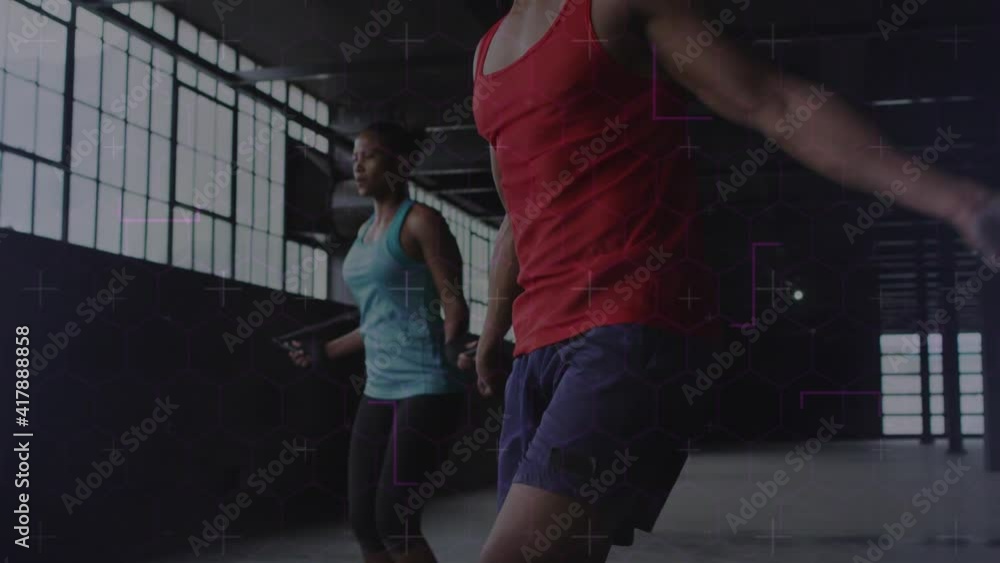 Poster animation of light trails moving over man and woman jumping with jumping ropes, exercising in gym