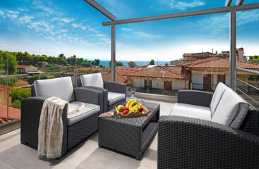 Recreation concept panorama of modern patio with wicker grey rattan furniture. Contemporary...