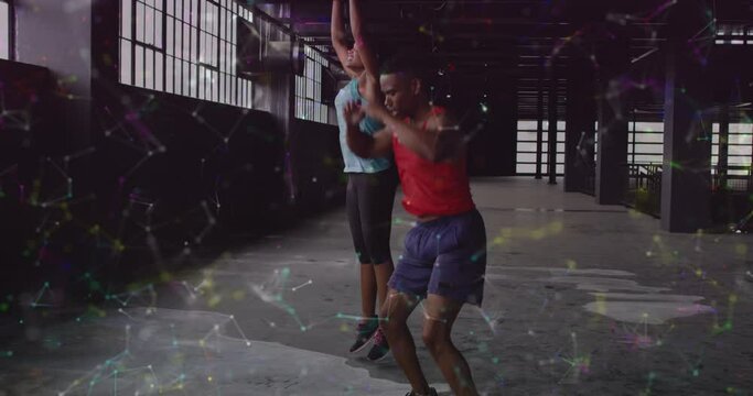 Animation Of Networks Of Connections Over Man And Woman Doing Burpees, Exercising In Gym