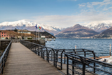 The lakeside promenade of Colico with the snow-capped Alps in the background
