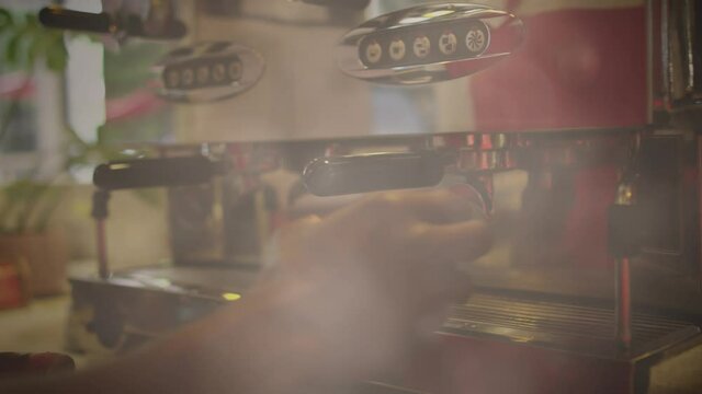 Animation of clouds and sunlight with hands of barista preparing coffee using machine