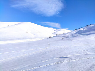 Fototapeta na wymiar snowy hills and blue sky