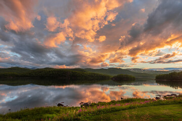 reflections at dawn on the lake of Vuoggatjalme, sweden