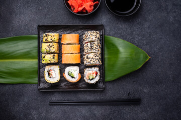 Traditional Japanese sushi rolls on dark background