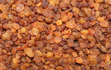 Background made of mixed brown raisins. Top view. Raisins backdrop. Healthy snack and food. Dry grapes.