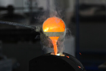 Pouring molten metal at the factory. Metallurgy concept, metal smelting. Being poured from the...