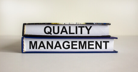 Quality management symbol. Concept words 'Quality management' on books on a beautiful white table,...