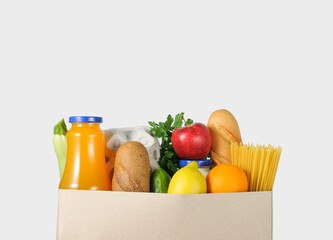 Food in a paper bag on gray background. Food delivery concept.Online shopping concept