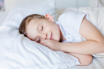 Cute boy sleeping in bed