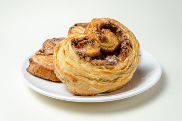 French sweet bun. On a white plate High quality photo