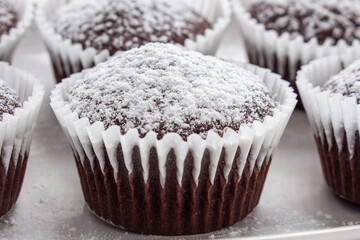 Several chocolate muffins on the white square plate