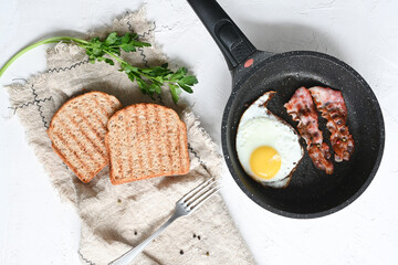 breakfast with fried eggs, toasts, and coffee on white background