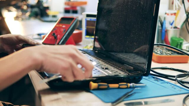 Laptop is getting dismantled by a repairman