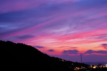 Mountain and sunset. Beautiful seascape with colorful sky.