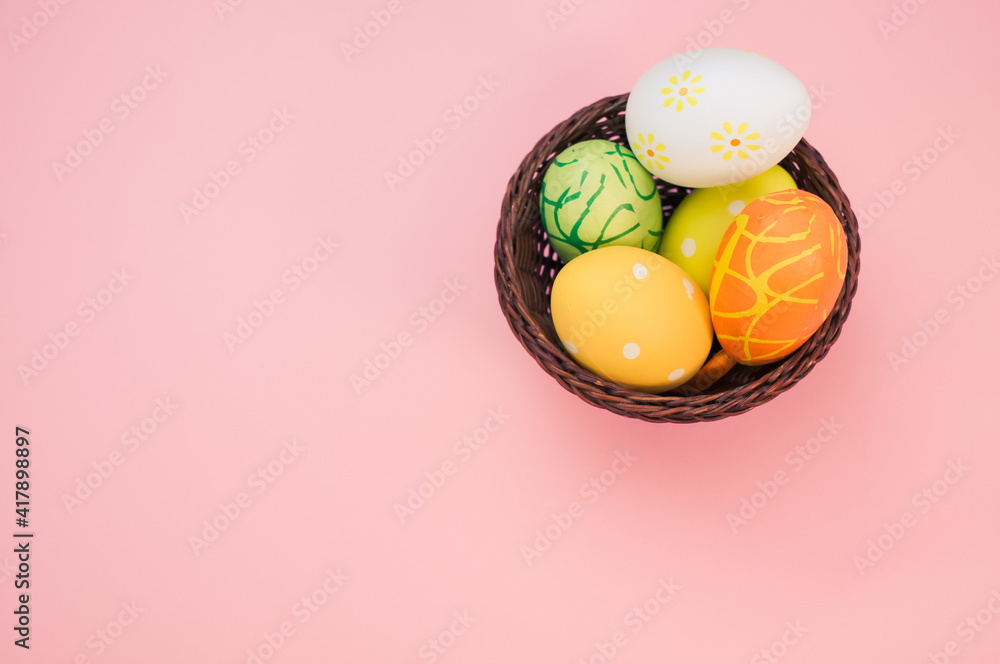 Poster easter eggs with beautiful patterns arranged in a basket