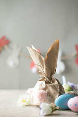 Fototapeta na wymiar Pom Pom Easter Bunny Craft. Easter bunny decoration paper gift. DIY holiday garland of colorful rabbits