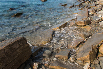 Seashore with stones, blue water. Black Sea.
