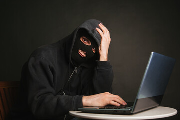A dangerous masked hacker with a hood cannot infiltrate the data servers and infect them with...