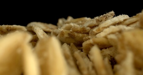 Macro shot of Oatmeal. Dry oat flakes detailed grain on black background. Oat Flakes Close-up. Concept of whole-grain food. High quality photo. - Powered by Adobe